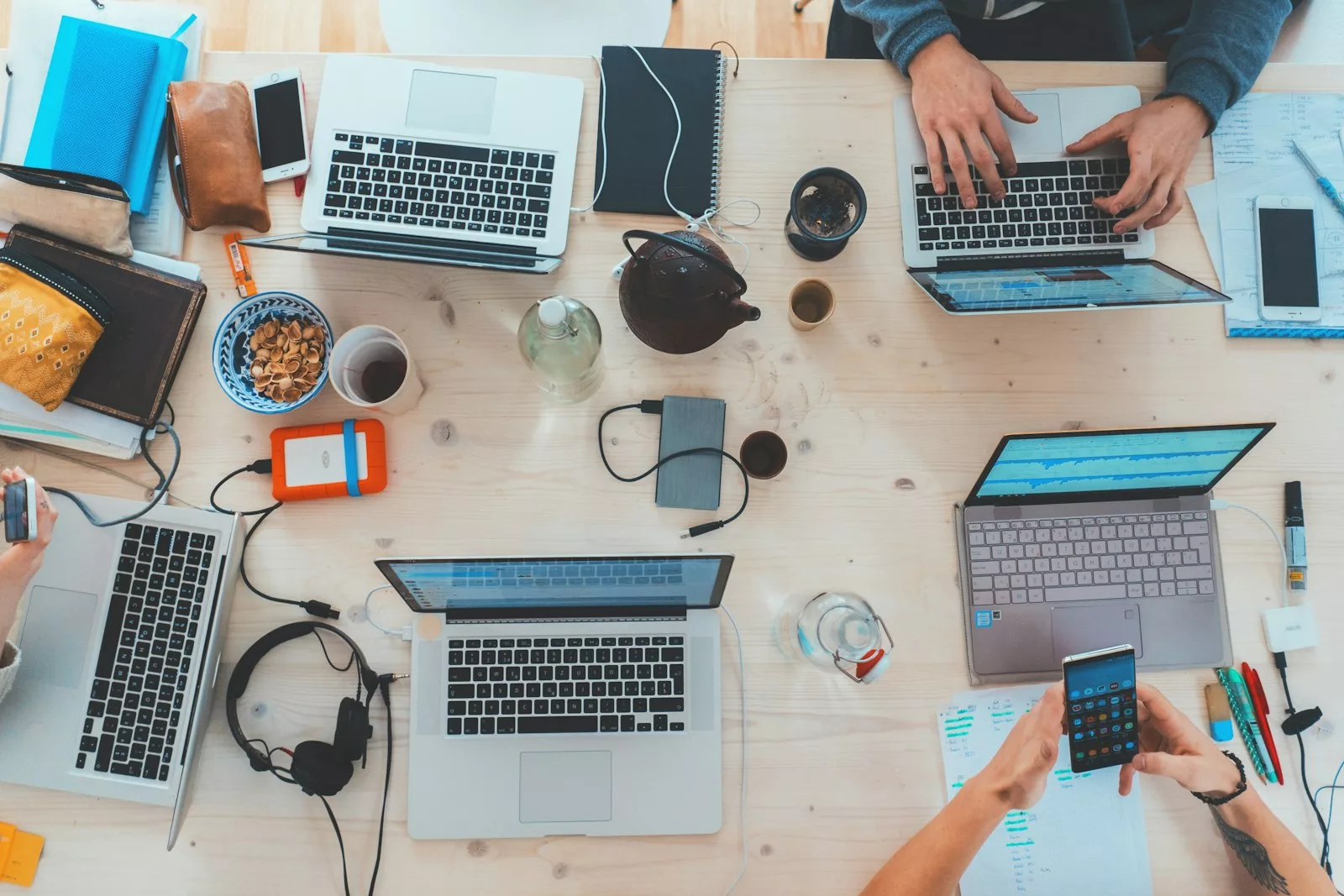Plusieurs ordinateurs et smartphones sur un bureau illustrant un abonnement IPTV multi-écrans 1, 3 ou 5 appareils